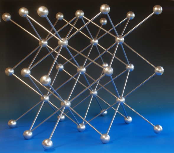 A large crystal structure model of potassium with the body centred cubic structure made with wood balls and aluminium rods 