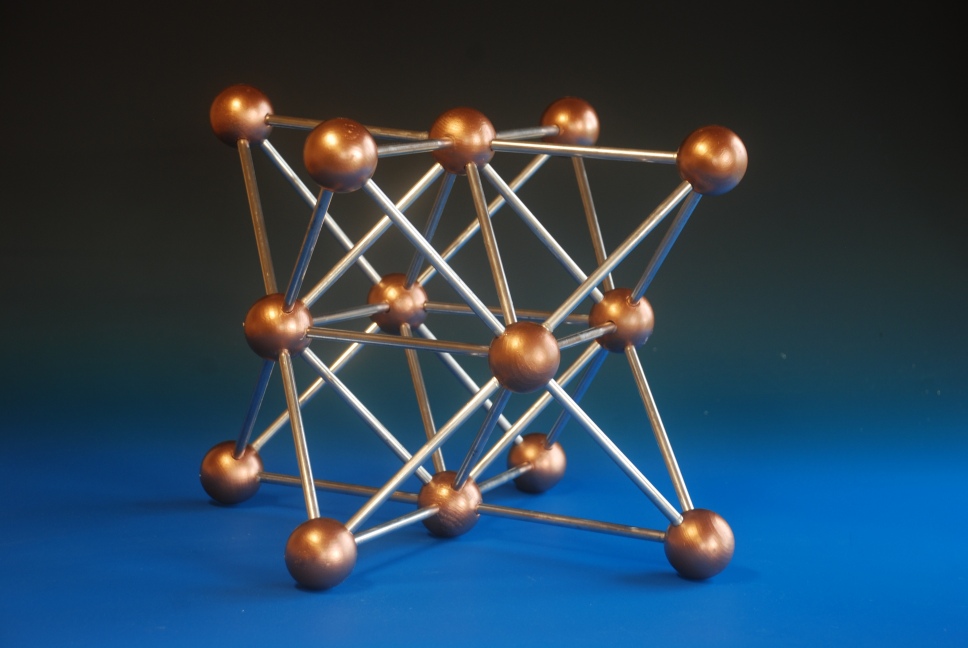 A large crystal structure model of Face centre cubic copper made with painted wood balls and aluminium rods