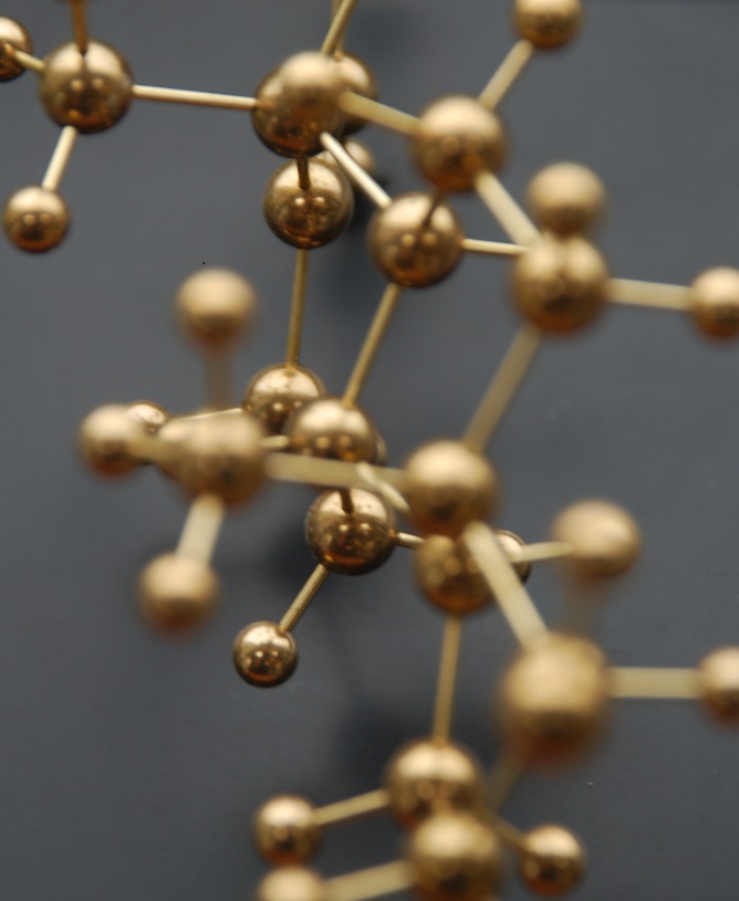 Detailed close up view of a brass molecular model of testosterone